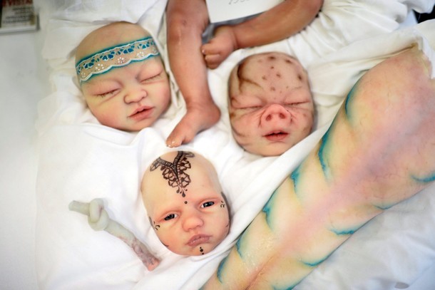 Heads and limbs of silicone babies are displayed at the Bilbao Reborn Doll Show, a trade fair featur