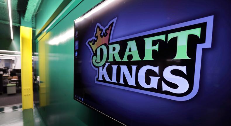 FILE - In this May 2, 2019, file photo, the DraftKings logo is displayed at the sports betting company headquarters in Boston. Sports daily fantasy and betting website DraftKings will debut as a publicly traded company Friday, April 24, 2020, against a backdrop of a near-complete shutdown of athletic competition across the globe due to the coronavirus pandemic. (AP Photo/Charles Krupa, File)