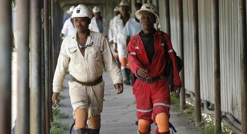 Miners walk at the end of their shift at the Anglo Platinum's Khuseleka shaft 1 mine in Rustenburg, northwest of Johannesburg, January 15, 2013. 