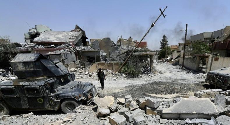 Iraqi security forces patrol west Mosul's al-Saha neighbourhood during their ongoing offensive to retake the city from Islamist fighters