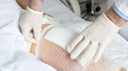 Mesh holds a knee replacement bandage in place.