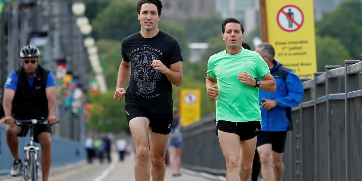 Canada's Prime Minister Justin Trudeau, left, runs with Mexico's President Enrique Pena Nieto across the Alexandra Bridge from Ottawa to Gatineau, Quebec, Canada, June 28, 2016.