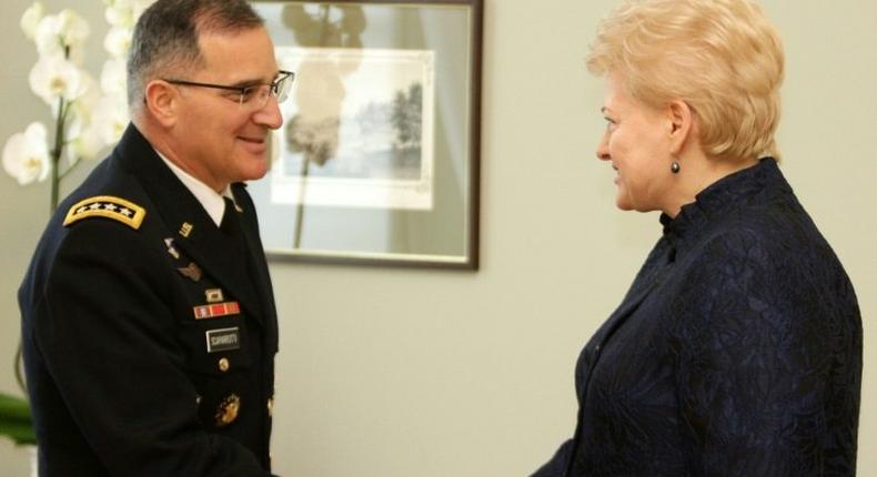 Lithuania's President Dalia Grybauskaite (R) shakes hand with Curtis Michael Scaparrotti, a four-star general in the US Army and Supreme Allied Commander Europe of NATO Allied Command Operations, during an official meeting in Vilnius on March 16, 2017