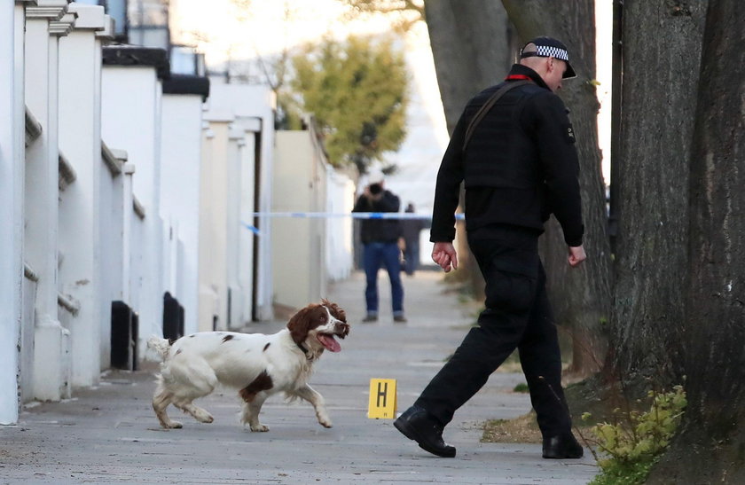 Police forensics officer works at the site where police fired shots after a vehicle rammed the parke