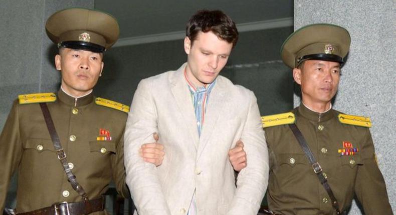 Otto Warmbier, being escorted by North Korean military officers