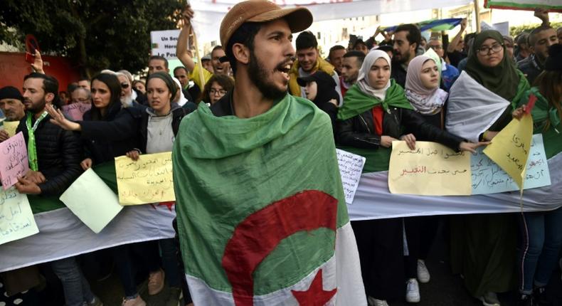 Algerian students and other protesters take part in an anti-government demonstration in the capital Algiers, on February 18