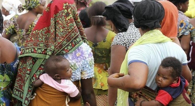 Women carry their children wait for the arrival of U.N. Secretary General Ban Ki-moon for the unveiling of a primary health care clinic in Dutse Makaranta village, on the outskirt of Nigeria's capital, Abuja May 23, 2011.