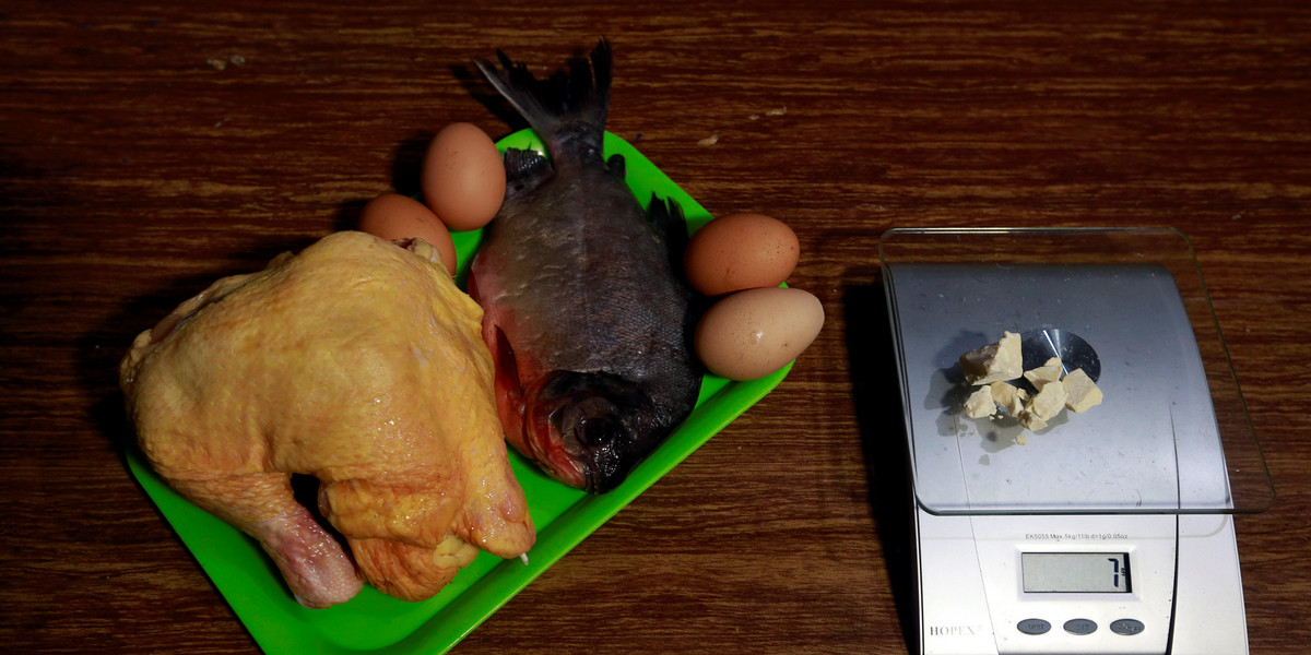 Chicken, fish, and eggs lie next to coca paste worth $14,000 Colombian pesos at a local store in Guyabero Region, Guaviare, Colombia.