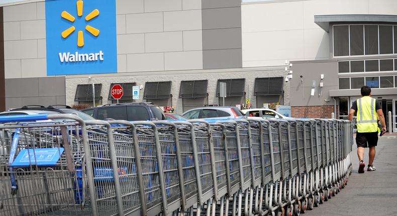 A worker collects shopping carts from the parking lot of a Walmart store in Chicago.Scott Olson/Getty Images
