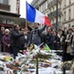 People pay tribute to victims outside Le Carillon restaurant, one of the attack sites in Paris