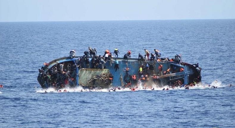 Migrants are seen on a capsizing boat before a rescue operation by Italian navy ships Bettica and Bergamini off the coast of Libya in this handout picture released by the Italian Marina Militare on May 25, 2016. 