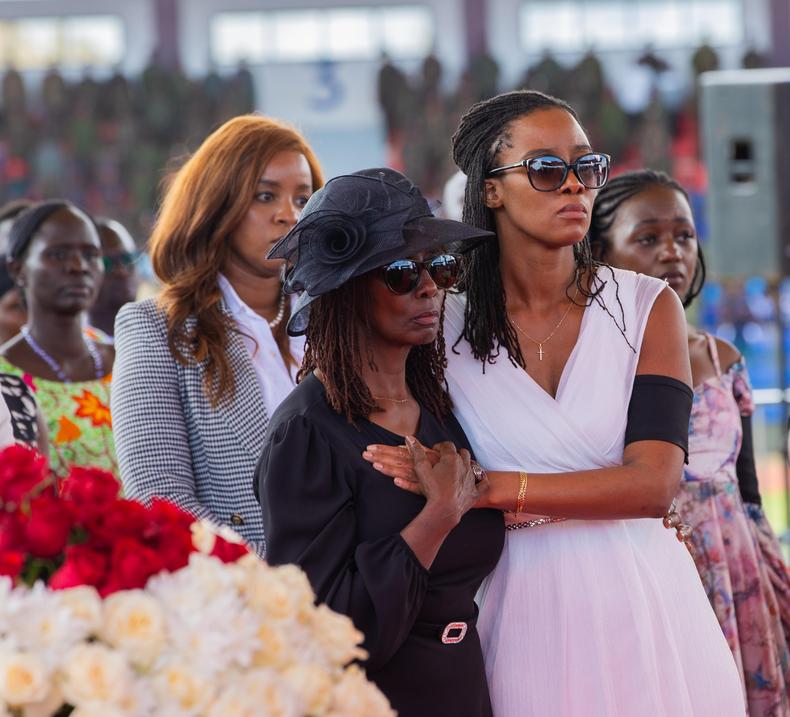 General Francis Ogolla's widow Aileen Kathambi (in black) is comforted during his memorial service