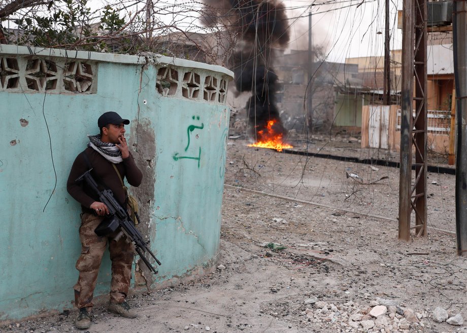 An Iraqi special forces soldier smokes as he takes a break during a battle between Iraqi special-forces soldiers and ISIS militants in Mosul, Iraq, March 1, 2017.