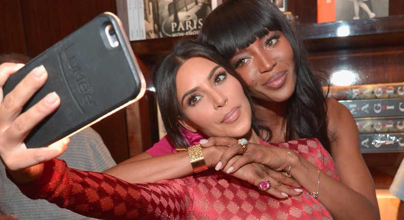 Kim Kardashian, left, snaps a selfie with Naomi Campbell using a LuMee case.