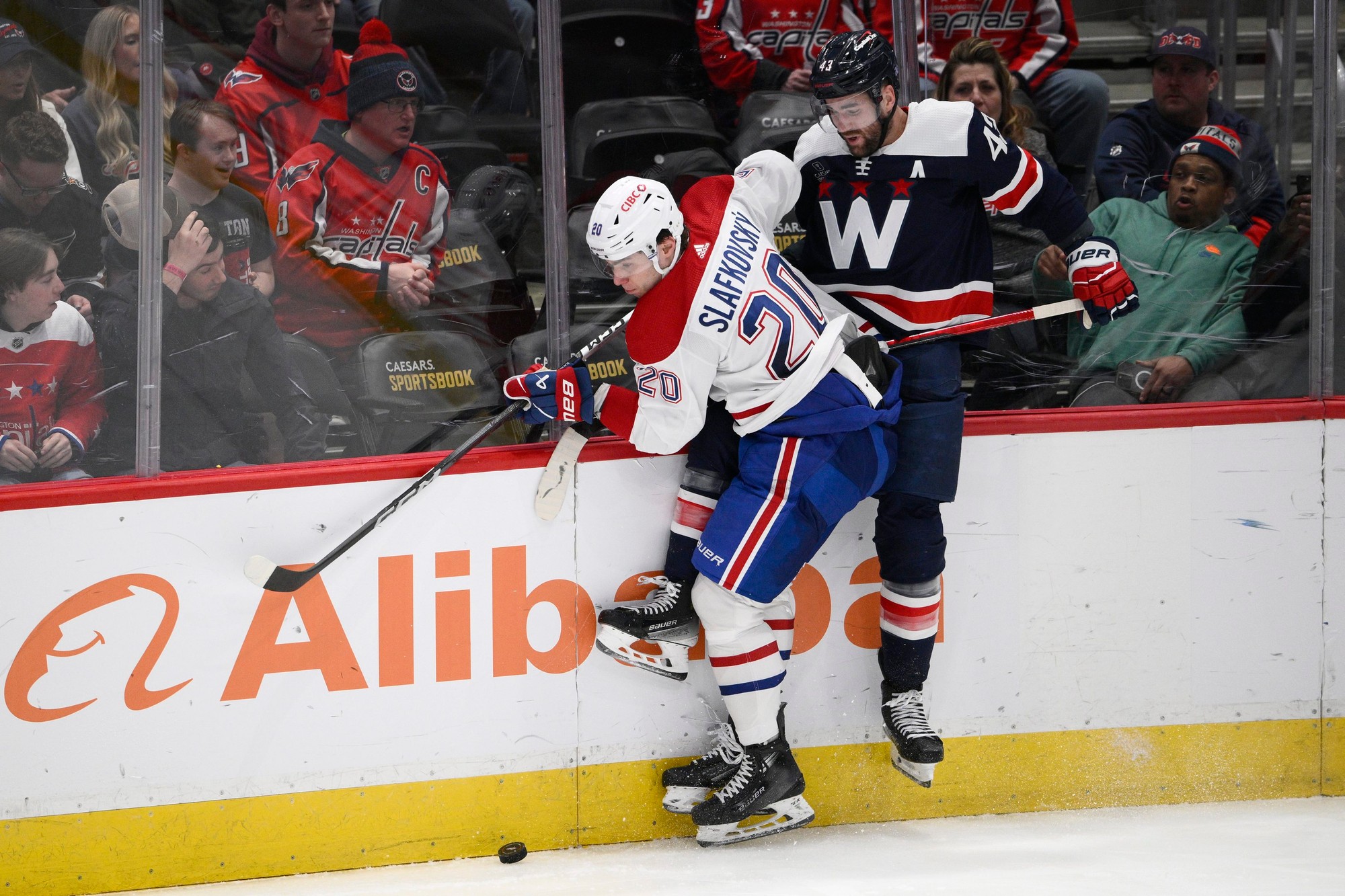 Slovenský hokejista Juraj Slafkovský (Montreal Canadiens) v súboji o puk.