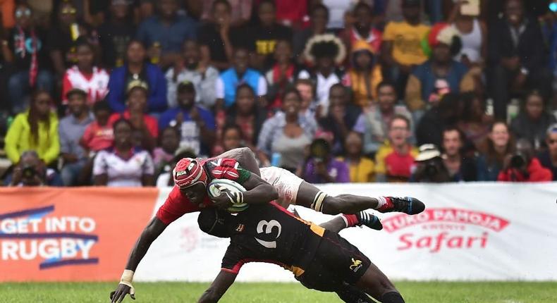 TOPSHOT - Uganda Cranes' centre, Michael Okorach (bottom) takes down Kenya's foward Oliver Mang'eni on July 7, 2018 during their 2019 Japan Rugby Union World Cup qualifying match - between Kenya and Uganda part of The Rugby Africa Gold Cup - in Nairobi on July 7, 2018. - Kenya won 38-22. (Photo by TONY KARUMBA/AFP via Getty Images)