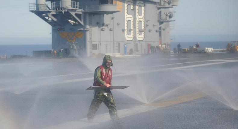 Washing down on the flight deck of the aircraft carrier USS Nimitz.