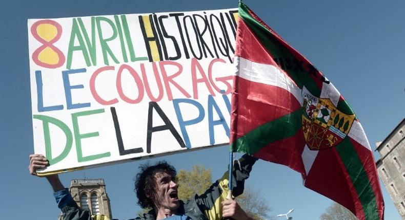 Jean-Baptiste Redde or  Voltuan, a well-known protester in France for his placards, holds a sign reading: Historic April 8, the courage of peace at a rally in Bayonne