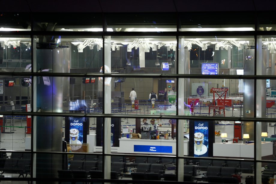 Officials walk inside Turkey's largest airport, Istanbul Ataturk, after a blast on June 28.