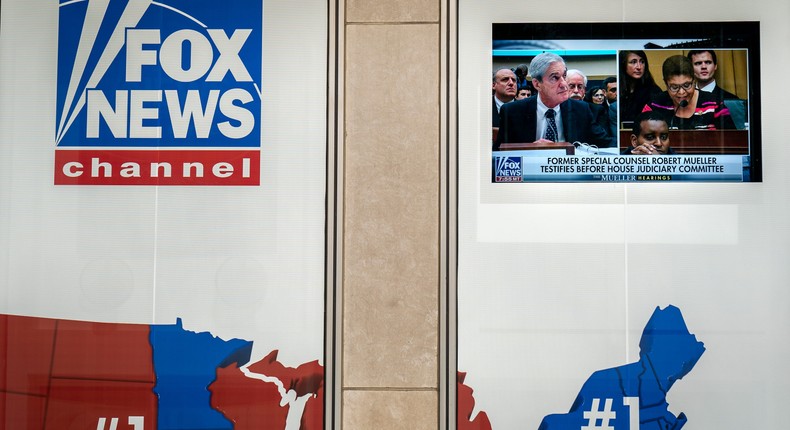 Former Special Counsel Robert Mueller's testimony to Congress is shown on a screen outside of the Fox News headquarters on July 24, 2019 in New York City.