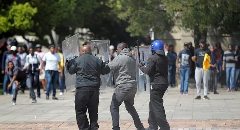 Students throw stones during clashes with security at Johannesburg's University of the Witwatersrand as countrywide protests demanding free tertiary education entered a third week, South Africa, September 20, 2016. 