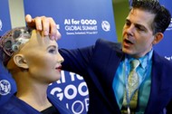 David Hanson of Hanson Robotics presents Sophia, a robot integrating the latest technologies and artificial intelligence is pictured during a presentation at the AI for Good Global Summit in Geneva