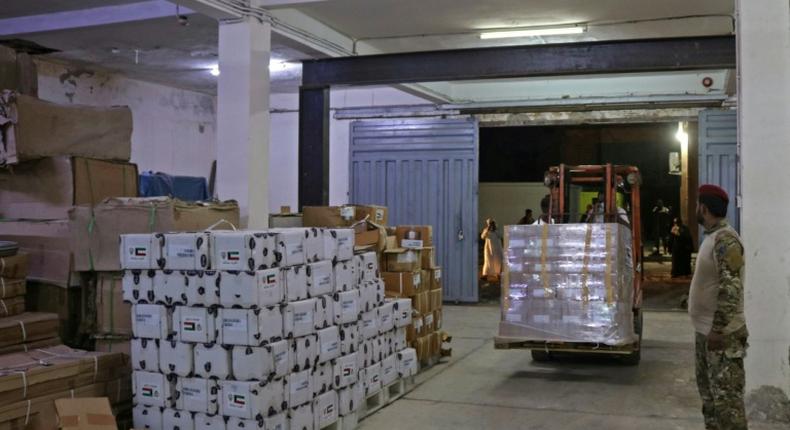 Yemeni men unload medical aid at a hospital warehouse in the war-torn country's second city of Aden, in early May