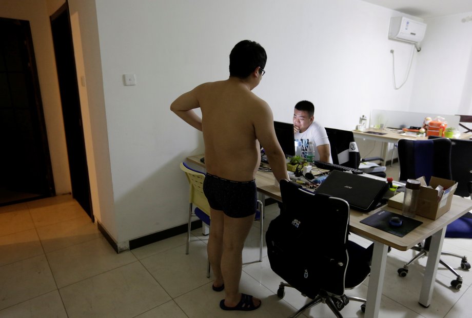 Some offices are run out of apartments, such as N-Wei (Beijing) Technology Company Limited. Here, a programmer chats with his colleague before he heads off to bed.