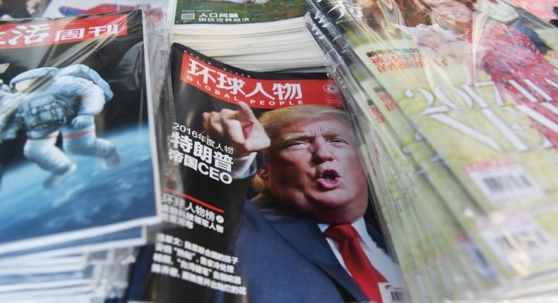 A Chinese magazine with a front page story naming US President-elect Donald Trump as their Person of the Year is seen at a news stand in Beijing