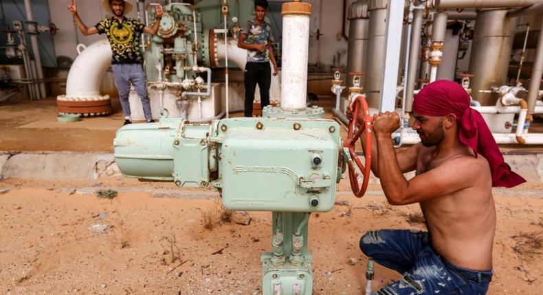 A Tunisian protester shuts down a valve blocking oil production in impoverished southern Tunisia amid growing demands by unemployed youths for jobs and the development of their marginalised region