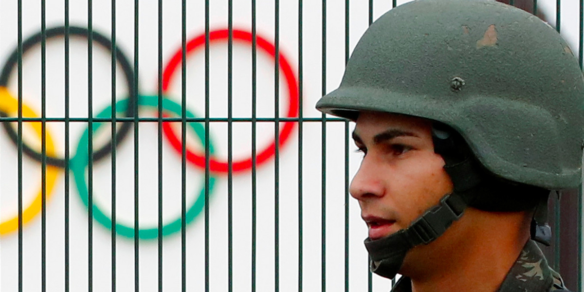 A Brazilian military police soldier patrols at the security fence outside the 2016 Rio Olympics Park in Rio de Janeiro, Brazil, July 21, 2016.