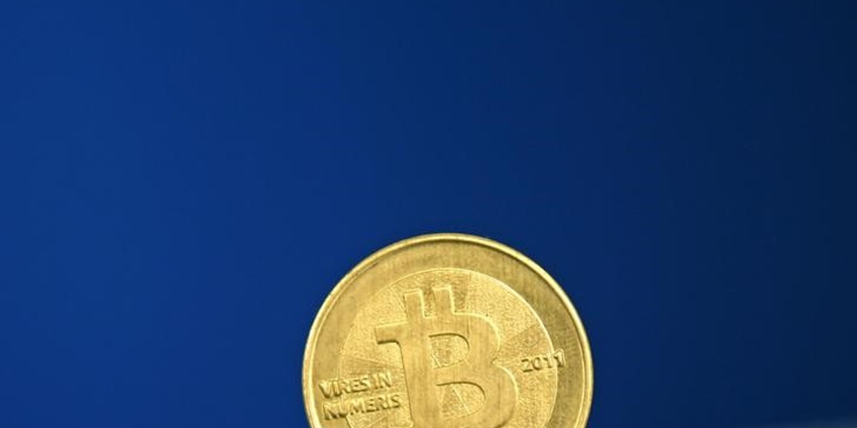 A Bitcoin, a kind of virtual currency, coin is seen in an illustration picture taken at La Maison du Bitcoin in Paris.