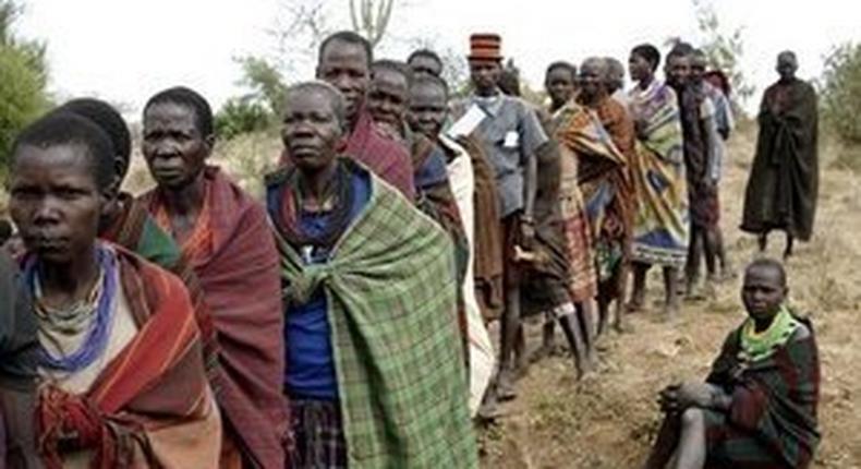 People from Karamojong tribe wait in line to vote at a polling station during elections in a village near the town of Kaabong in Karamoja region, Uganda February 18, 2016. REUTERS/Goran Tomasevic