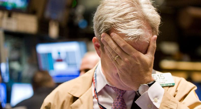 A trader at the New York Stock Exchange puts his hand on his face in September 2008.Richard Drew/AP