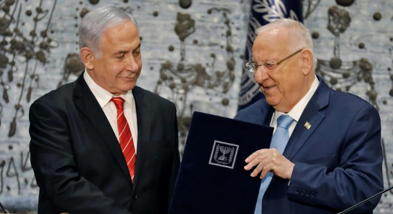 Israeli President Reuven Rivlin gives veteran incumbent Benjamin Netanyahu the potentially impossible task of forming a majority coalition while battling the looming threat of corruption charges