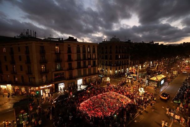 People gather at an impromptu memorial where a van crashed into pedestrians at Las Ramblas in Barcel