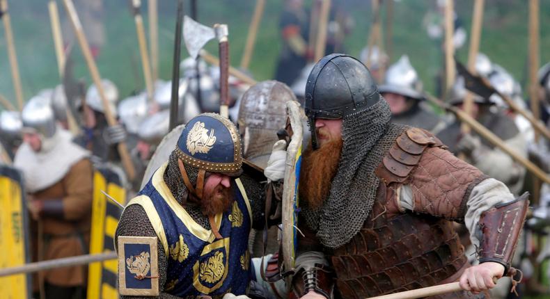 Enthusiasts wearing medieval knight costumes fight during a battle in the central Bohemian village of Libusin April 26, 2014.