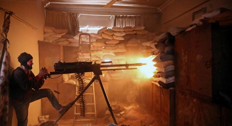 A Syrian opposition fighter fires a heavy machine gun in Jobar, a rebel-held district on the eastern outskirts of the Syrian capital Damascus, on March 19, 2017