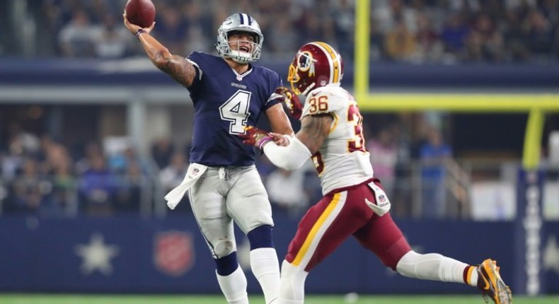 Dak Prescott of the Dallas Cowboys rolls out to pass during the fourth quarter against the Washington Redskins at AT&T Stadium