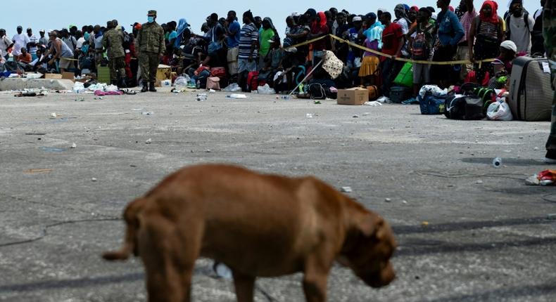 People await evacuation at a dock in devastated Marsh Harbour, Bahamas, on September 7, 2019, in the aftermath of Hurricane Dorian