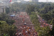 A Philippine flag flutters as devotees parade the black statue of Jesus Christ during the annual Bla