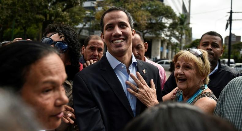 Venezuelan opposition leader and self declared acting president Juan Guaido greets supporters at a demonstration called by supporters in the transportation sector, in Caracas on February 20, 2019