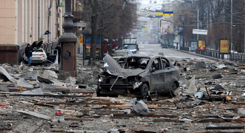 A burnt-out car is seen on the street after a missile launched by Russian invaders hit near the Kharkiv Regional State Administration building in Svobody (Freedom Square) on March 1, 2022, in Kharkiv, Ukraine.