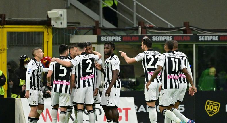 Udinese players celebrate with teammate Destiny Udogie (4L) after his equaliser at the San Siro Creator: MIGUEL MEDINA