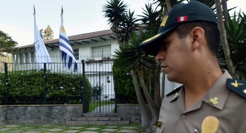 A policeman stands guard outside the residence of Uruguay's ambassador to Peru, after former Peruvian President Alan Garcia requested asylum amid a probe into alleged bribes paid by a Brazilian contractor during his second term in office