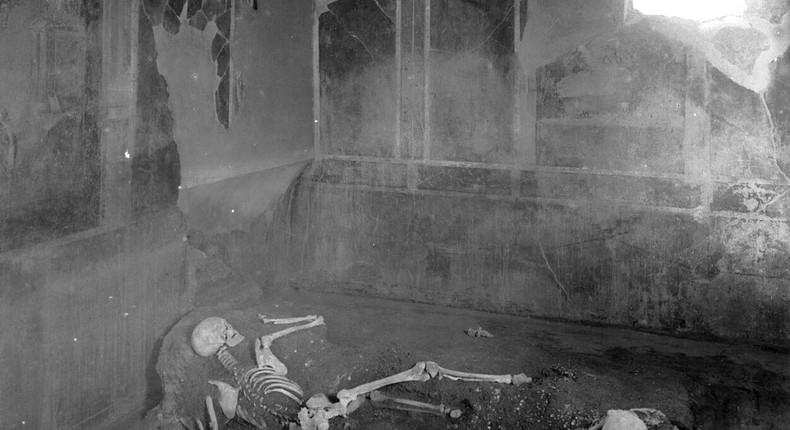 Two individuals, a man and a woman, laying as they died in the House of the Craftsman in Pompeii, Italy.