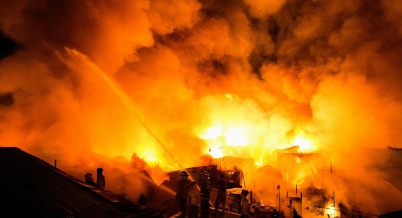 Firefighters battle the fire in Delpan, Tondo, Manila on February 7, 2017