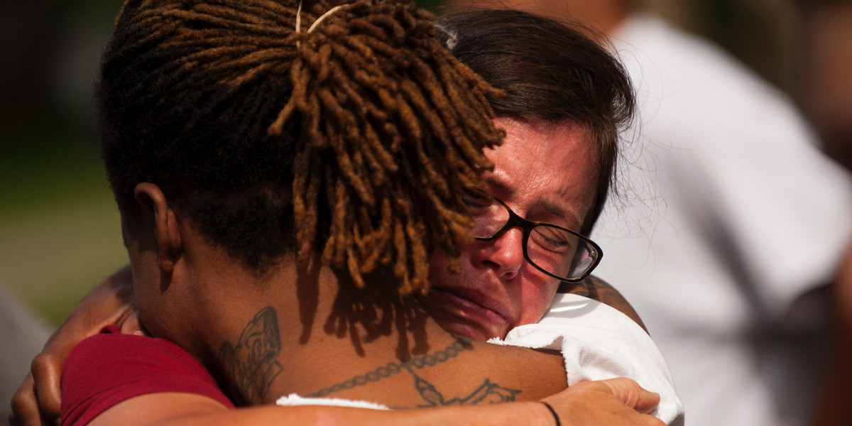 Two people embrace during a demonstration for Philando outside the Governor's Mansion following the police shooting death of a black man on July 7, 2016 in St. Paul, Minnesota.
