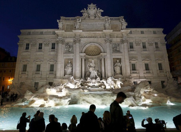 People take pictures during an opening ceremony of Rome's Trevi Fountain