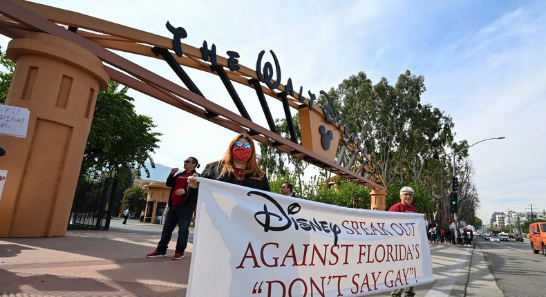 Members of the AIDS Healthcare Foundation urge Disney to speak out against the Don't Say Gay bill.Dan Steinberg/AP